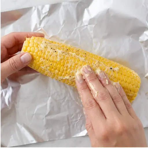 Step 2: Rubbing butter onto each ear of corn