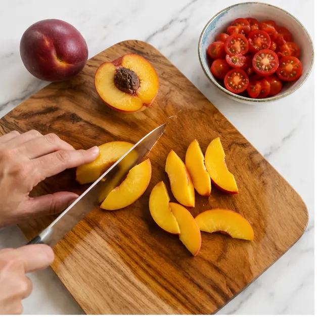 Step 1: Slice peaches and halve cherry tomatoes