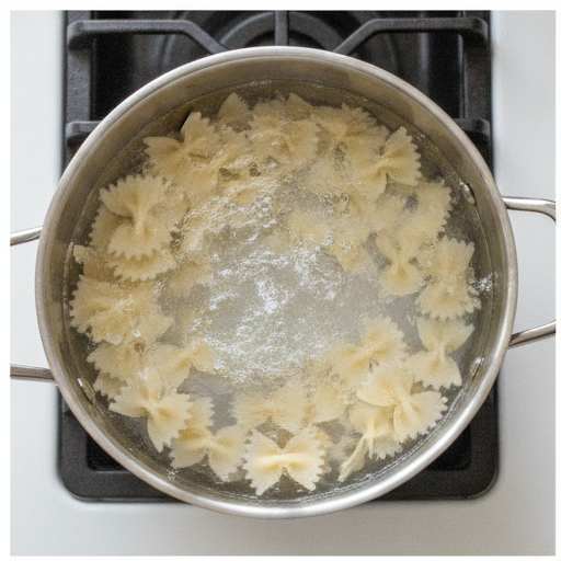 Boiling bow tie pasta for the salad