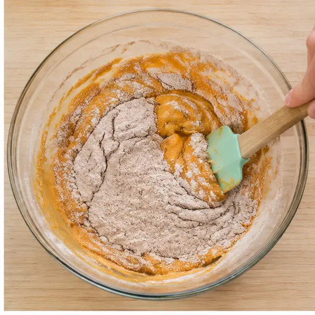 Folding the spice cake mix into the wet batter until just combined