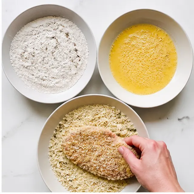 Step 2: Dredging cutlets through the panko-cheese breading station