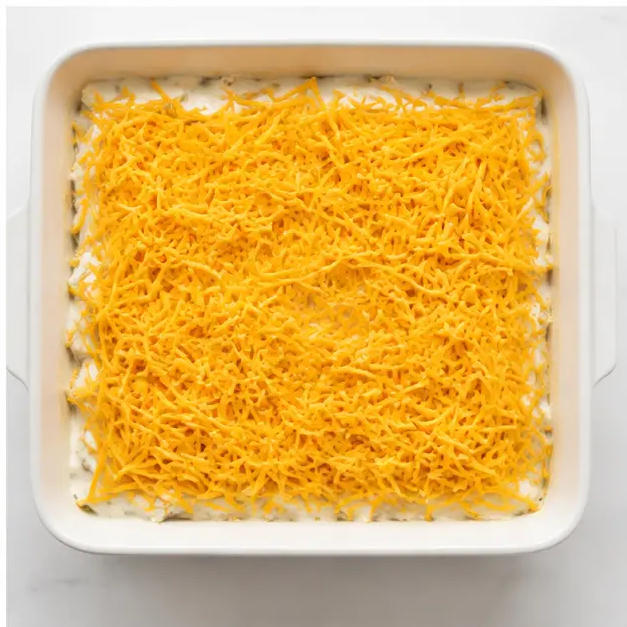 Step 4: Sprinkling cheddar cheese on top before baking