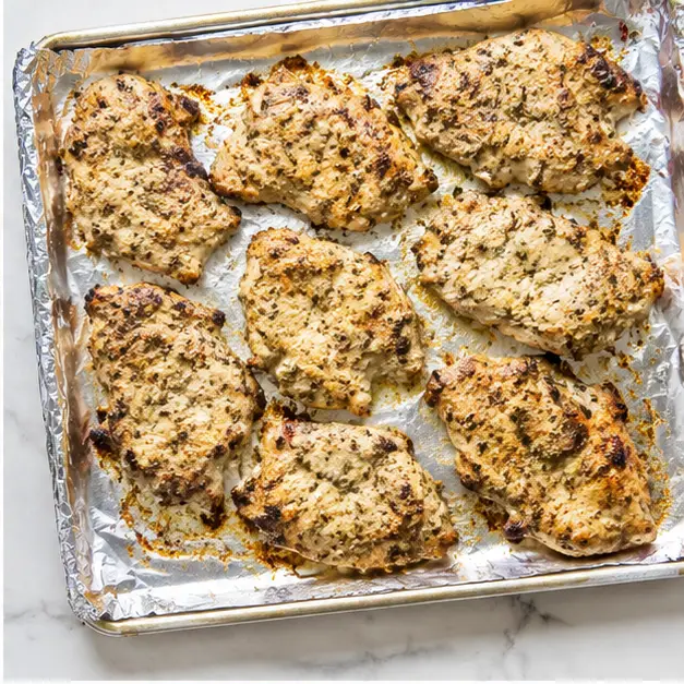 Broiling marinated chicken until charred and cooked