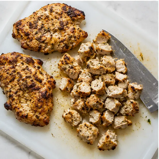 Chopping rested chicken into bite-size pieces