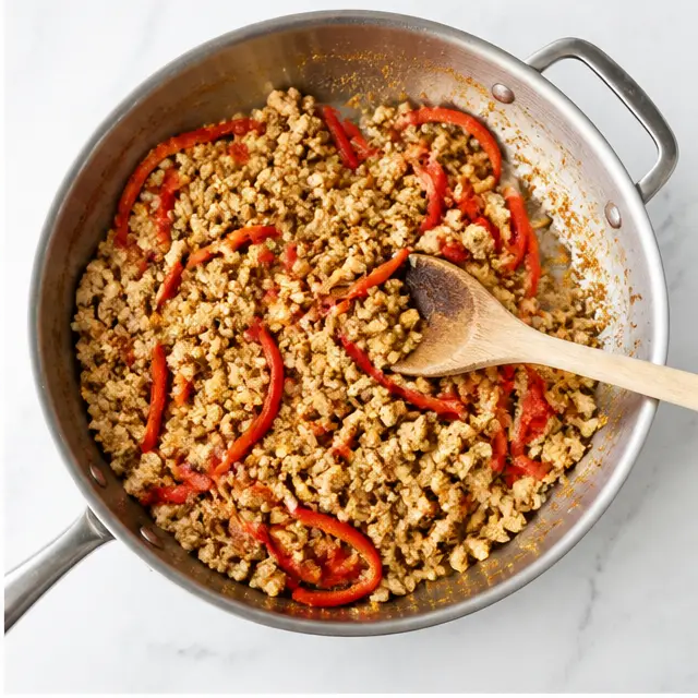 Step 2: Browning ground chicken with red bell pepper in a hot skillet