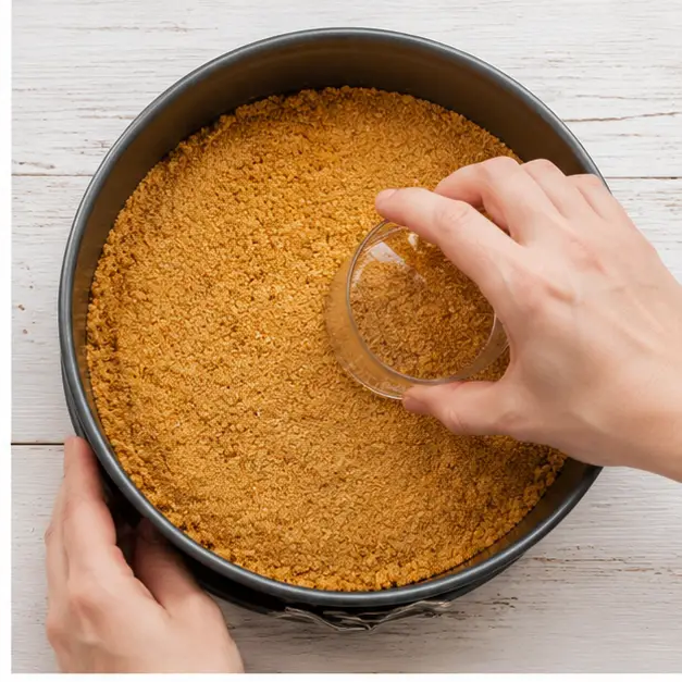 Step 2: Press buttery graham cracker crumbs into the springform pan