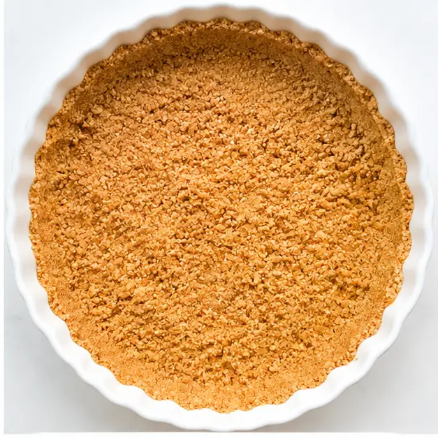 Press the buttery crumb mixture into a 9-inch pie dish and prebake until set and lightly golden.