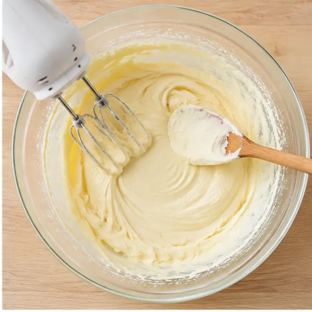Beating the cream cheese batter until perfectly smooth.