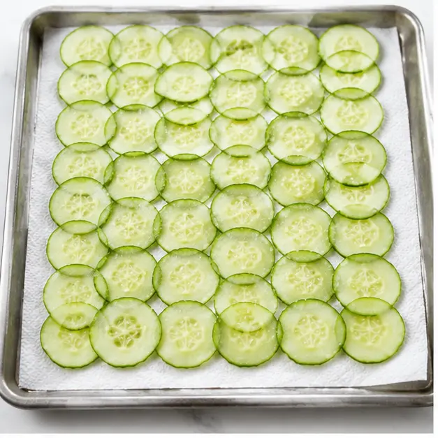 Step 1: Salt cucumber slices in a single layer to draw out moisture