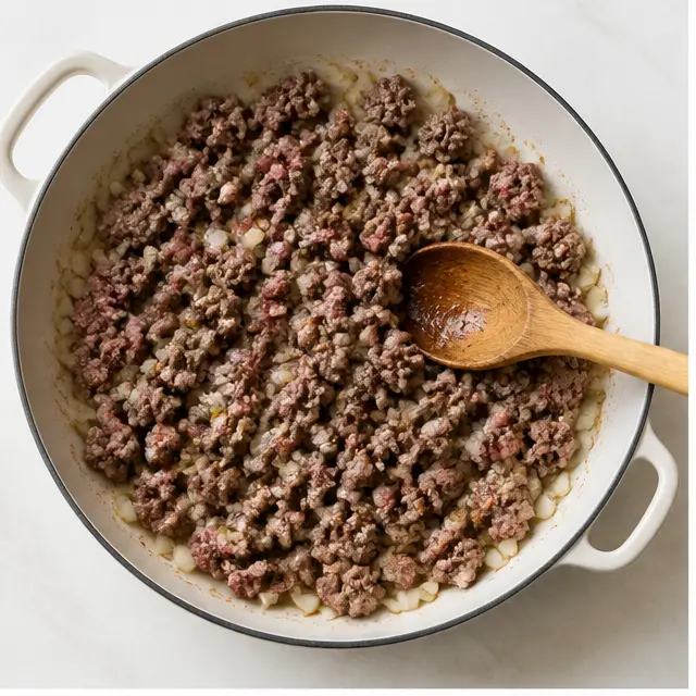 Brown the ground beef with diced onion until no pink remains