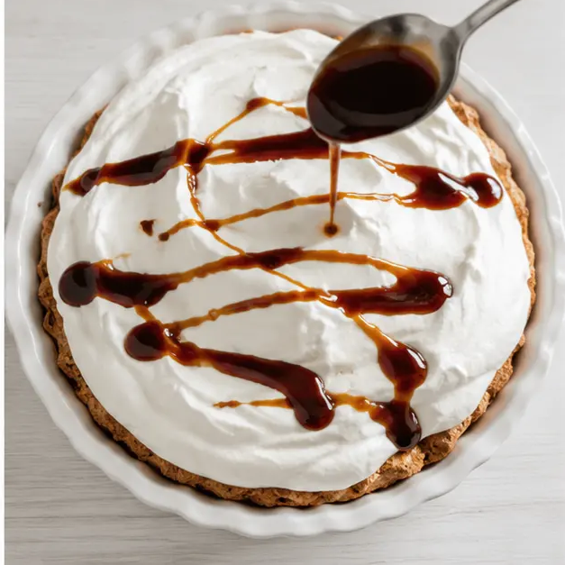 Step 4: Drizzling reduced cola syrup over whipped topping on the chilled pie