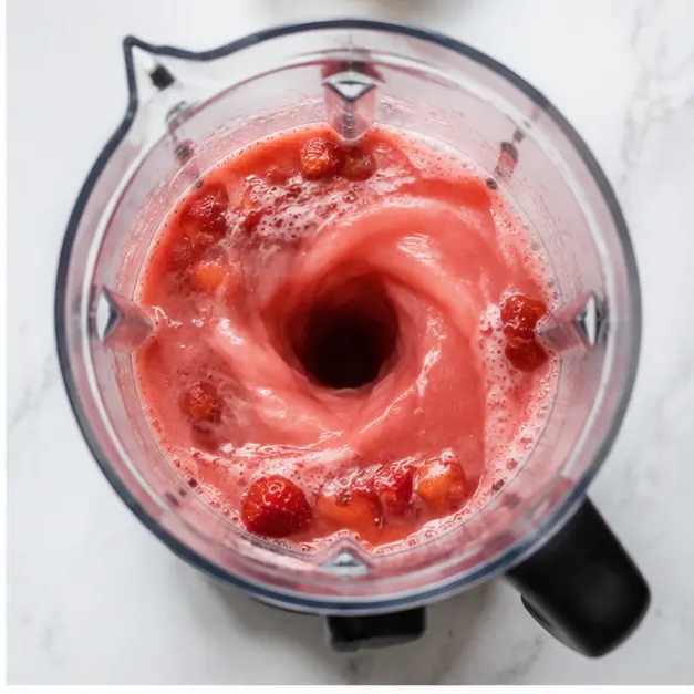 Step 2: Blending strawberries with citrus juices, sugar, and water until silky smooth