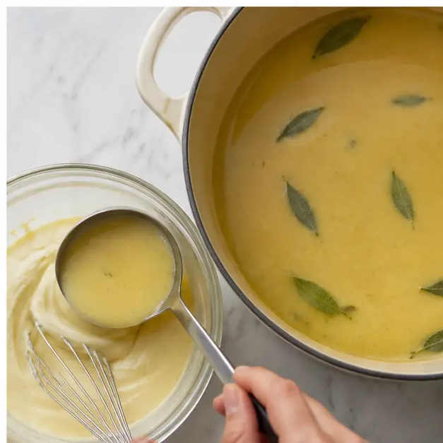 Step 4: Temper the aioli with hot soup and whisk it into the pot