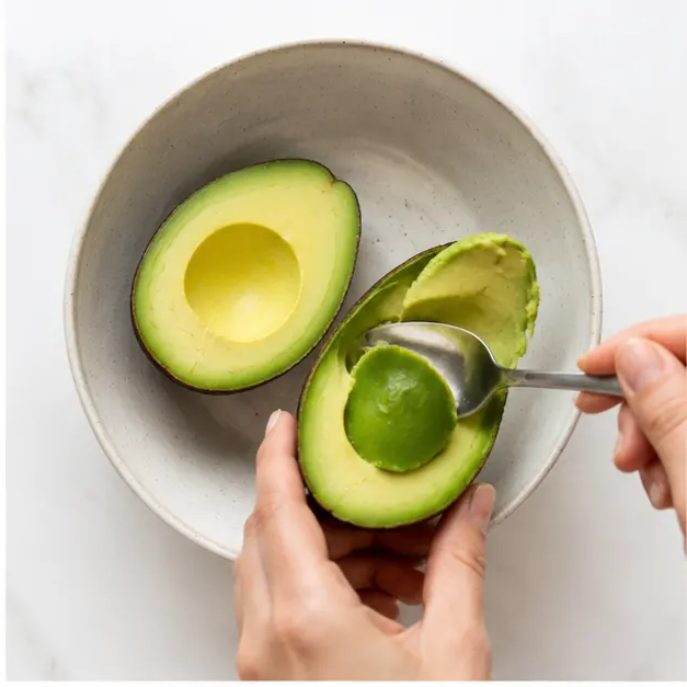 Scoop and mash the avocado with lemon, oil, and salt