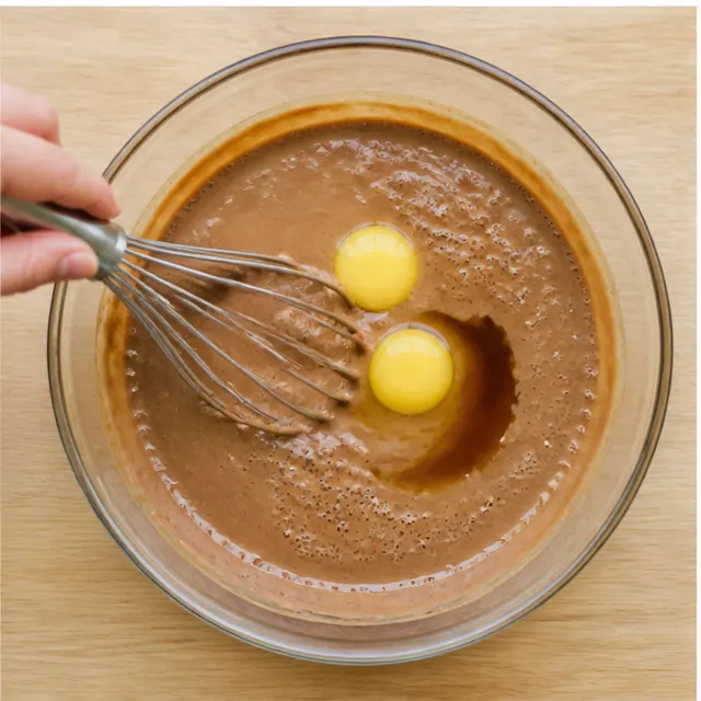 Beat in the eggs and vanilla until thick and pale