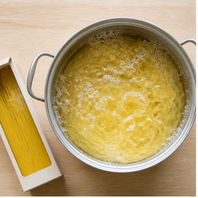 Step 1: Boiling the dried capellini pasta in generously salted water until just tender