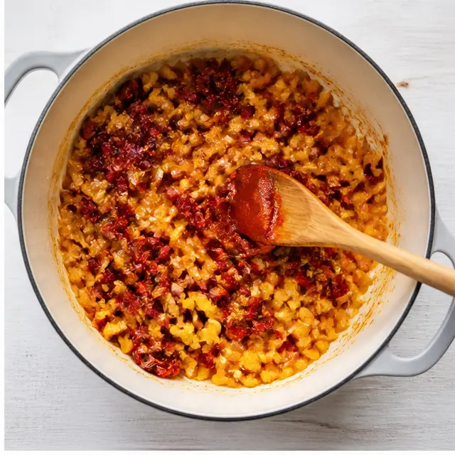Step 2: Stir in sun-dried tomatoes and tomato paste until caramelized