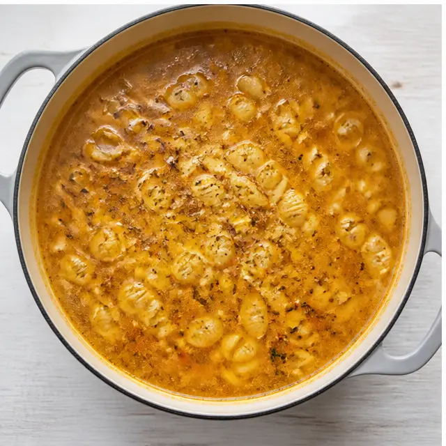 Step 3: Simmer shell pasta in seasoned chicken broth until al dente