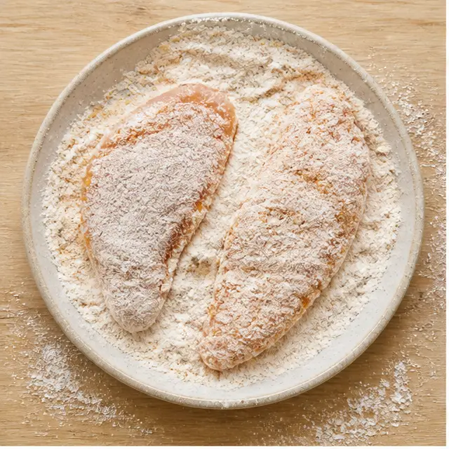 Step 1: Dredging chicken fillets through seasoned flour