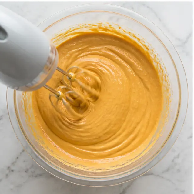 Stage 3: Beating the pumpkin cream cheese filling until smooth