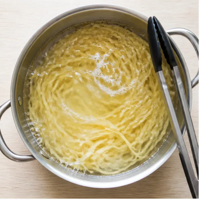 Boiling linguine in salted water until al dente
