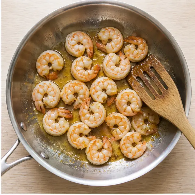 Searing shrimp until pink and curled into a C-shape