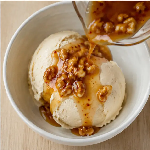 Step 4: Drizzling the spicy umami maple topper over the churned ice cream