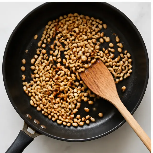 Step 3: Toasting pine nuts in a dry skillet until golden