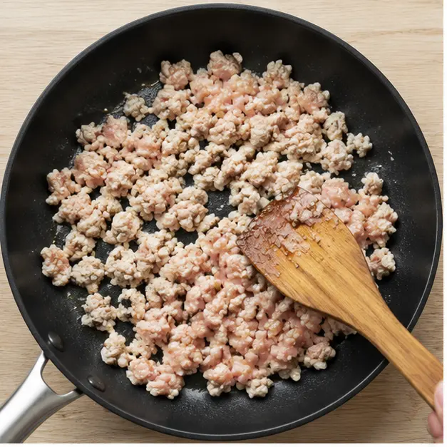 Step 1: Browning ground chicken in a large skillet, breaking it into small crumbles