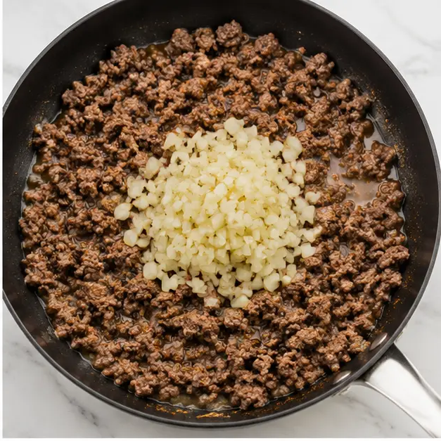 Step 2: Brown ground beef with diced yellow onion