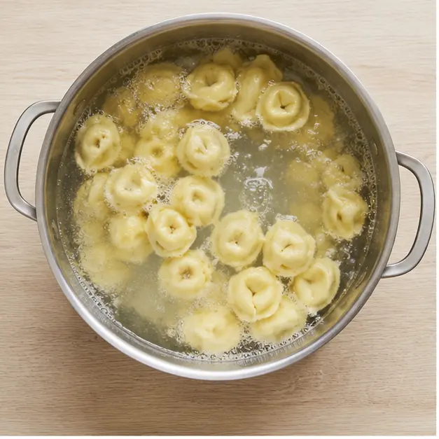 Step 1: drop raw cheese tortellini pasta into a large pot of rolling salted boiling water